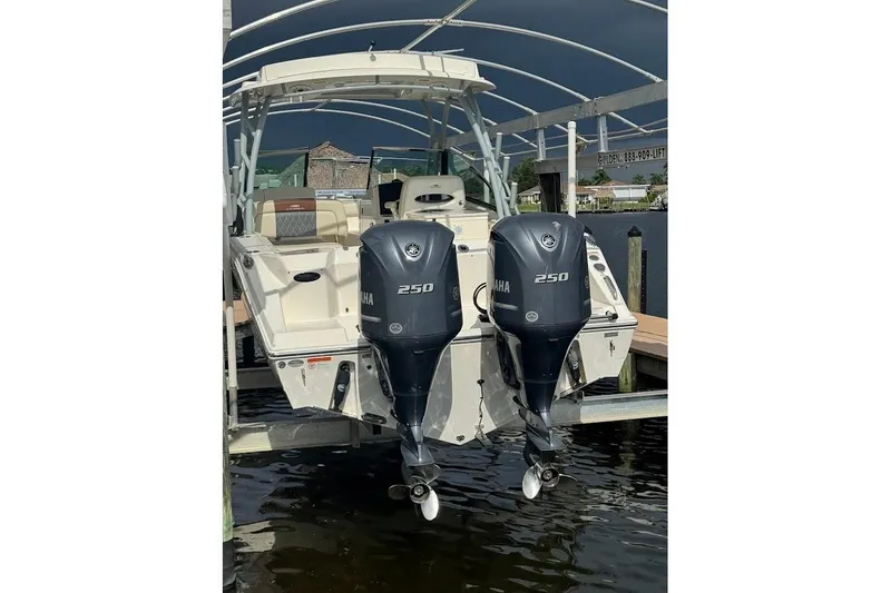 Slide: The Image of 2020 Cobia 280 Dual Console boat with twin Yamaha 250 engines docked. - 48