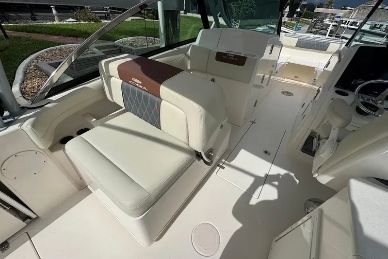 Slide: The Image of 2020 Cobia 280 Dual Console boat interior with beige seating and modern design. - 29