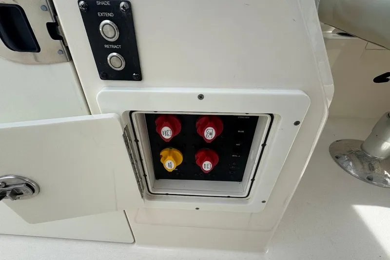 Slide: The Image of Control panel on a 2020 Cobia 280 Dual Console boat with switches and knobs. - 25