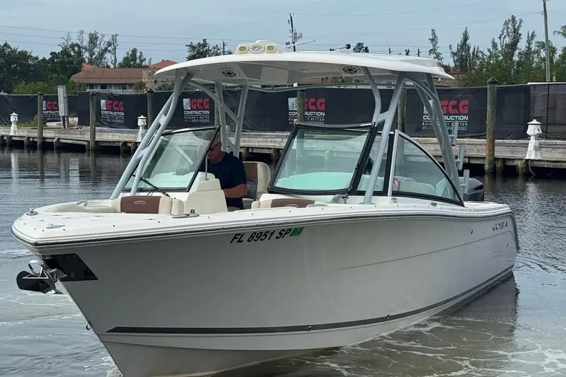 Slide: The Image of 2020 Cobia 280 Dual Console boat docked in a marina setting. - 8