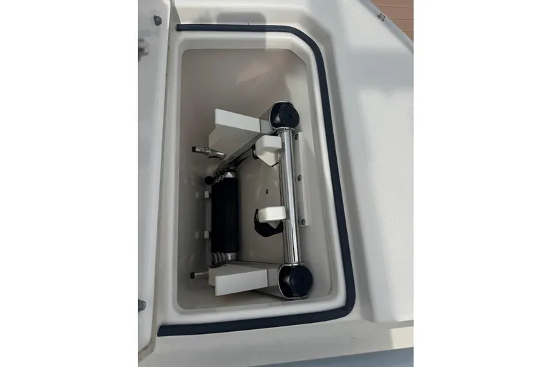 Slide: The Image of Storage compartment of a 2020 Cobia 280 Dual Console boat, featuring a neatly organized interior. - 15