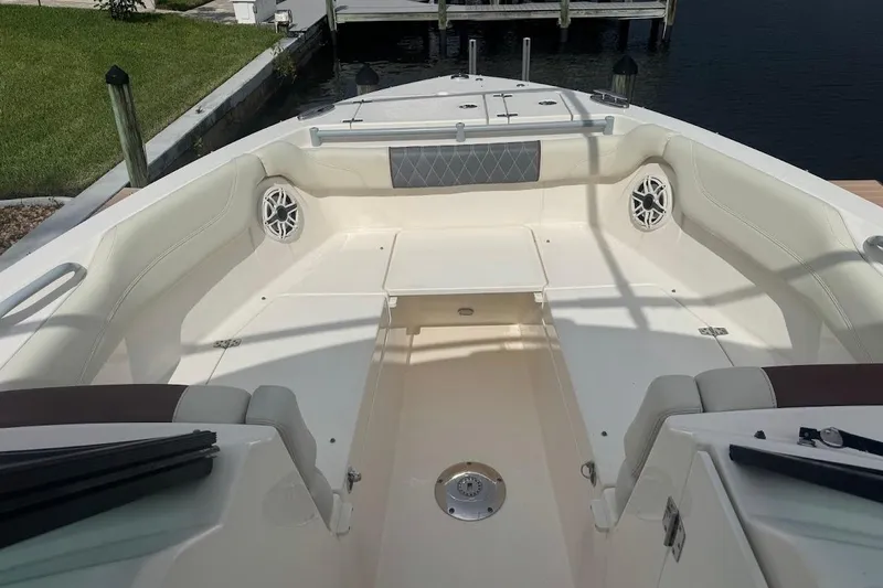 Slide: The Image of 2020 Cobia 280 Dual Console boat interior with spacious seating and speakers. - 18