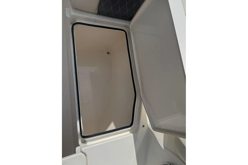 Slide: The Image of Open storage compartment on a 2020 Cobia 280 Dual Console boat. - 20