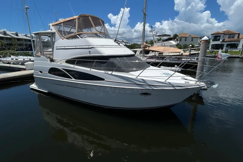 Slide: The Image of 2005 Carver 36 Motor Yacht docked in a marina under a clear blue sky. - 1
