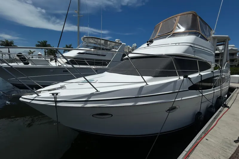 Slide: The Image of 2005 Carver 36 Motor Yacht docked at marina under clear blue sky. - 3