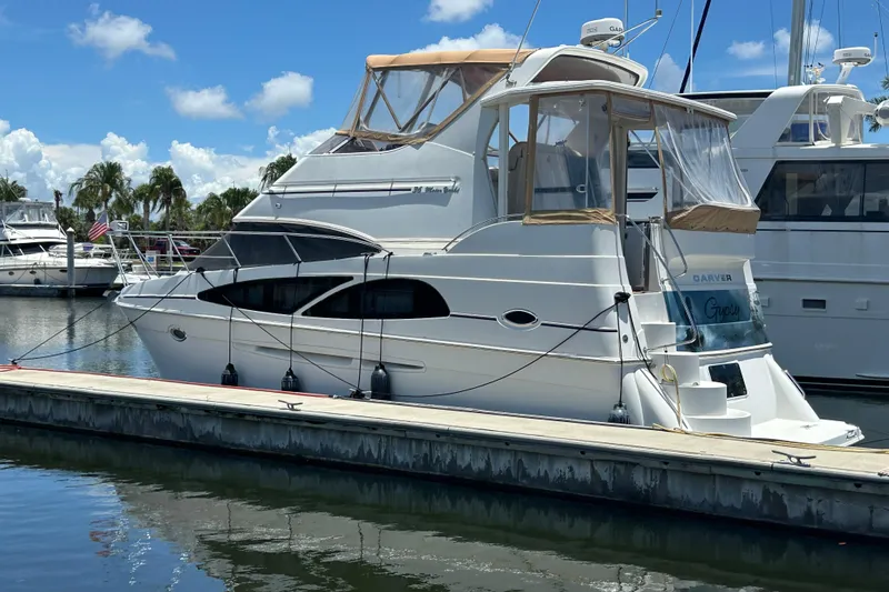 Slide: The Image of 2005 Carver 36 Motor Yacht docked at marina under clear blue sky. - 4