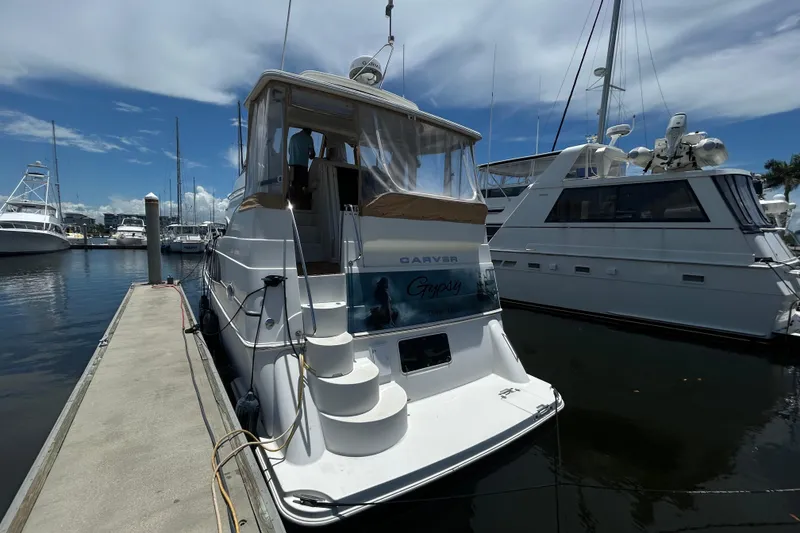 Slide: The Image of 2005 Carver 36 Motor Yacht docked at marina under clear sky. - 5