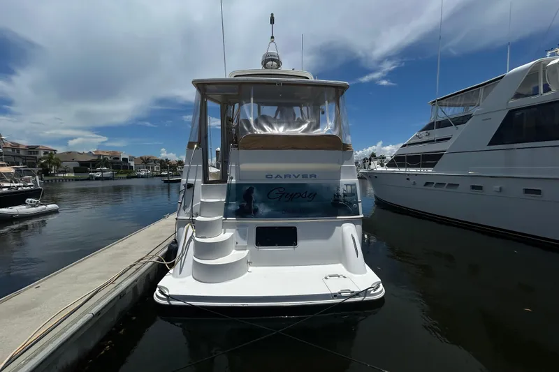 Slide: The Image of 2005 Carver 36 Motor Yacht docked in a marina under a clear blue sky. - 6