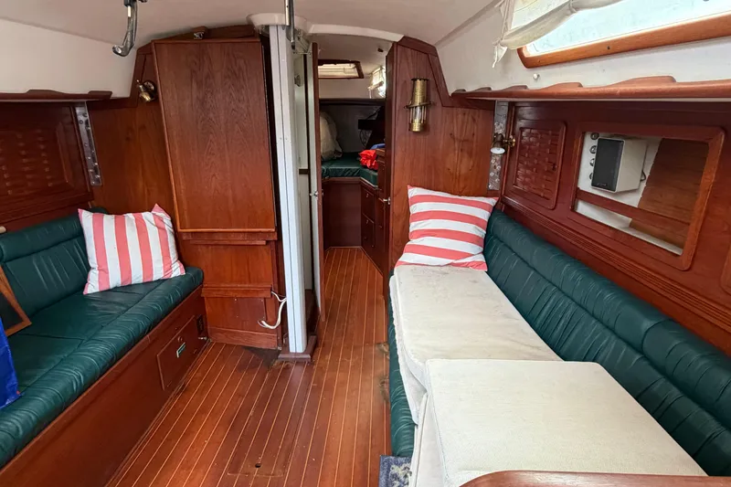 Slide: The Image of Interior of 1989 Sabre 34 MK II sailboat with wood paneling and striped cushions. - 12