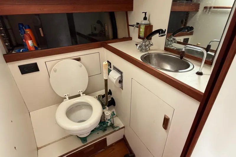 Slide: The Image of 1989 Sabre 34 MK II yacht bathroom with toilet, sink, and mirror. - 13