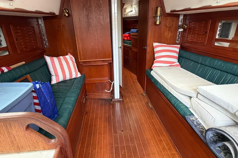 Slide: The Image of Interior of 1989 Sabre 34 MK II sailboat with wood paneling and striped cushions. - 2