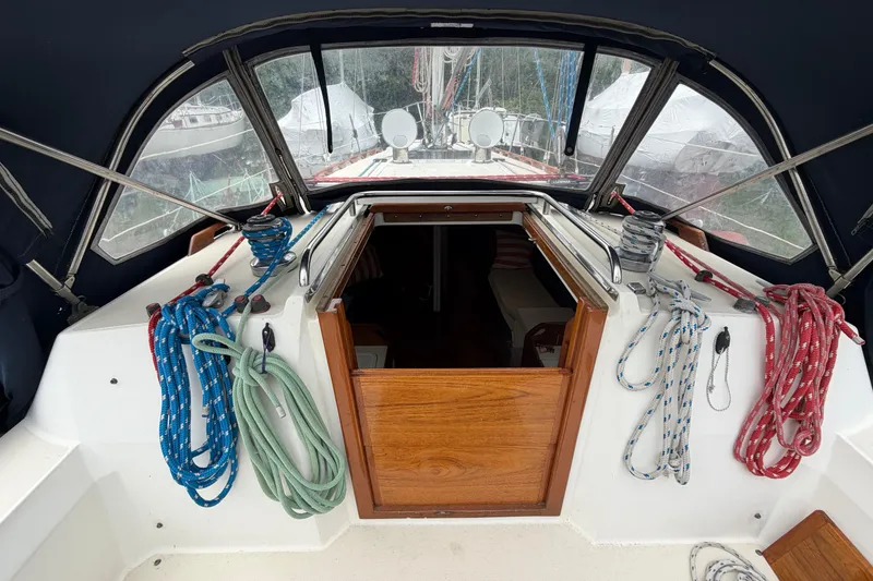 Slide: The Image of Cockpit of 1989 Sabre 34 MK II sailboat with ropes and wooden hatch. - 22