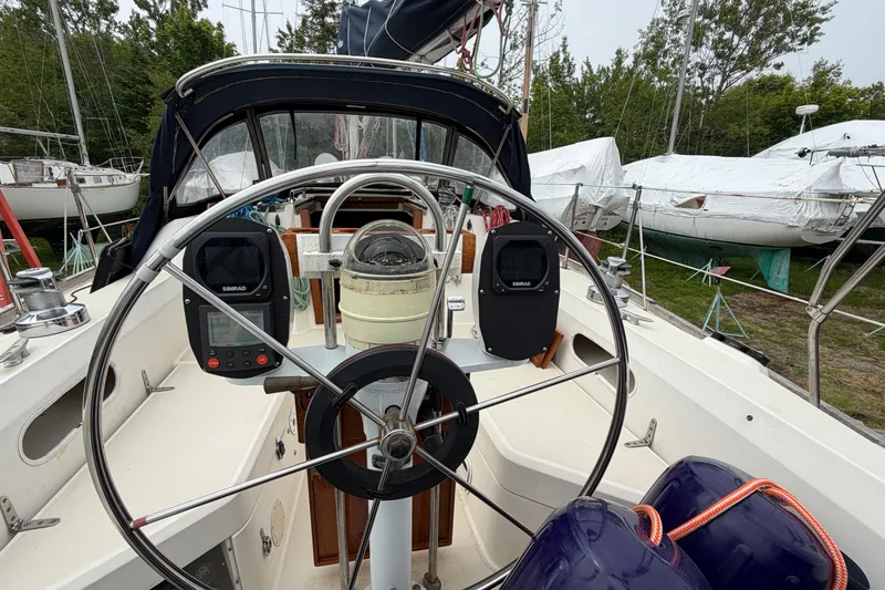 Slide: The Image of Cockpit of 1989 Sabre 34 MK II sailboat with steering wheel and navigation instruments. - 24