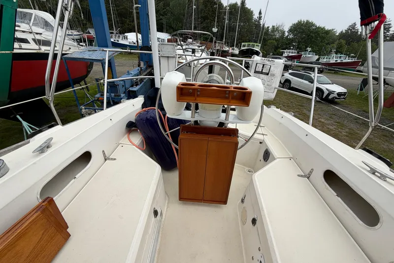Slide: The Image of Cockpit view of 1989 Sabre 34 MK II sailboat with steering wheel and wooden paneling. - 27