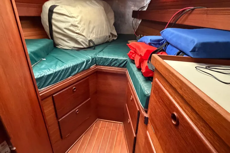 Slide: The Image of Cozy cabin interior of 1989 Sabre 34 MK II sailboat with wooden cabinetry and cushions. - 8
