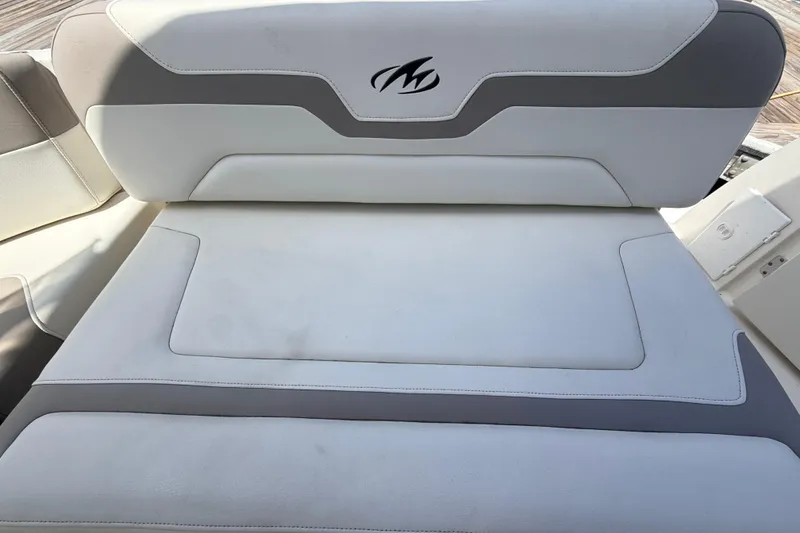 Slide: The Image of White and gray seating on 2011 Monterey 320 Sport Yacht, featuring logo detail. - 12