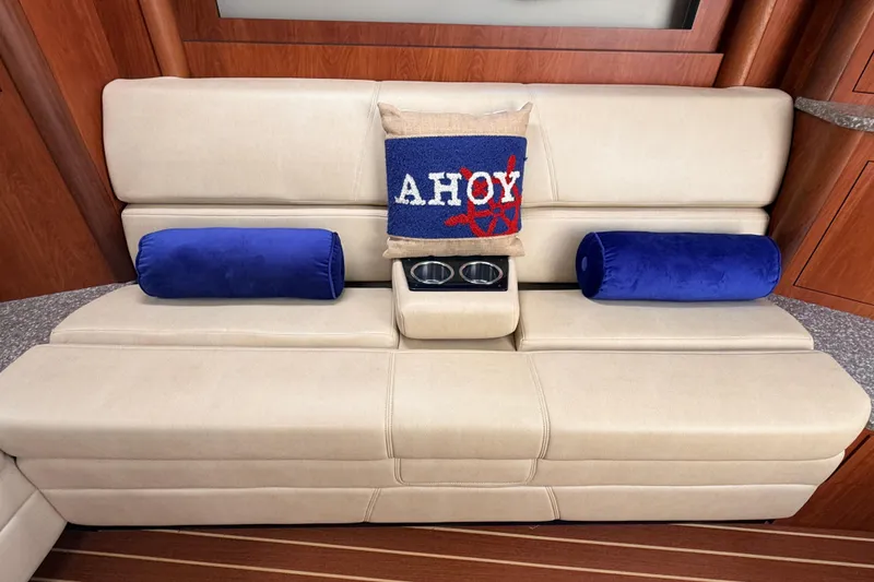 Slide: The Image of Luxurious beige seating with nautical-themed pillows on a 2011 Monterey 320 Sport Yacht. - 19