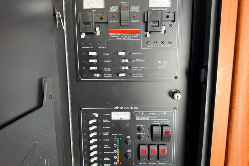 Slide: The Image of Electrical control panel of a 2011 Monterey 320 Sport Yacht, featuring switches and indicators. - 29