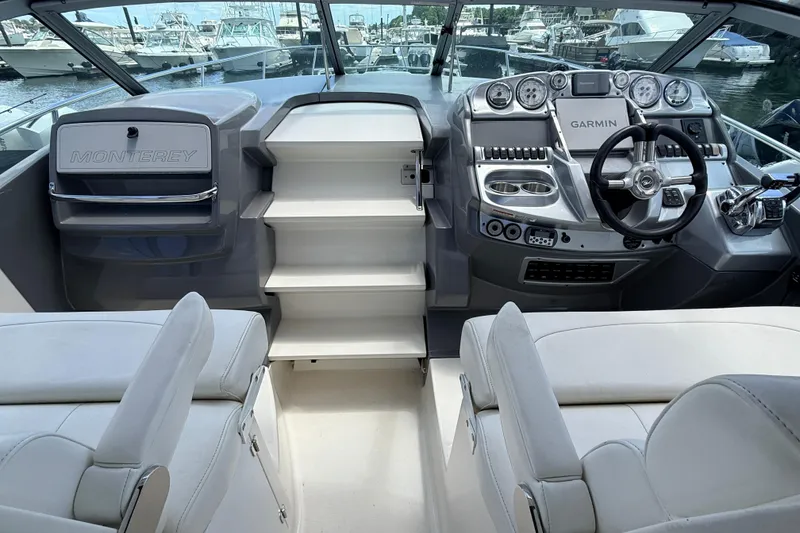 Slide: The Image of Interior of a 2011 Monterey 320 Sport Yacht with modern dashboard and seating. - 4