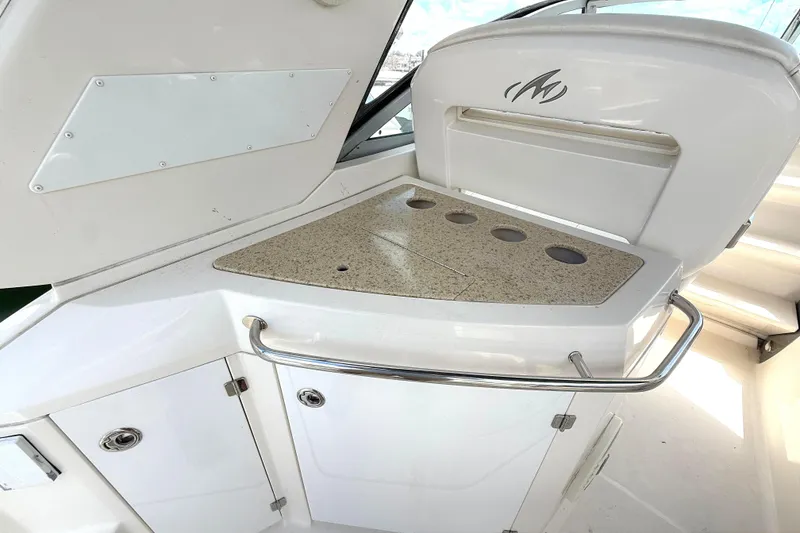 Slide: The Image of 2011 Monterey 320 Sport Yacht interior with sleek countertop and storage cabinets. - 7