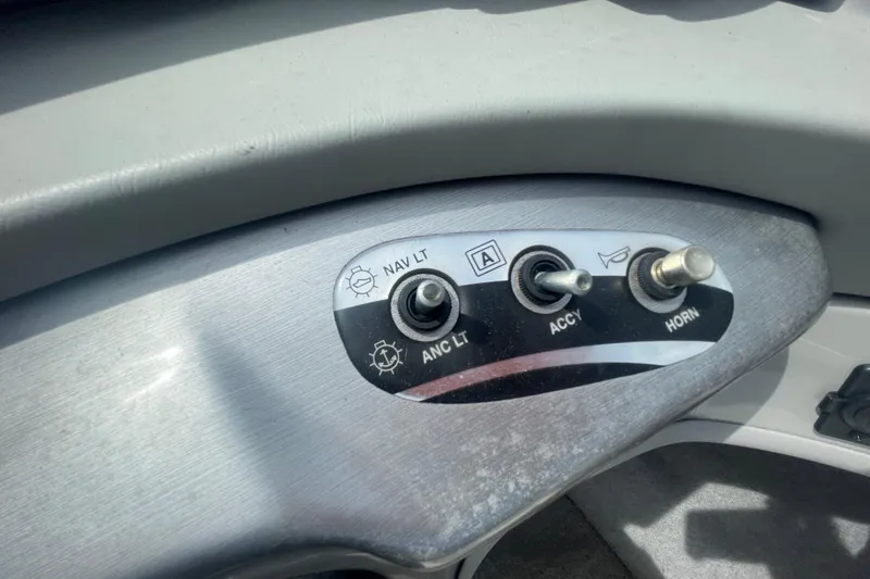 Slide: The Image of Dashboard switches on a 2008 Bayliner 195 Bowrider boat, including navigation and horn controls. - 13