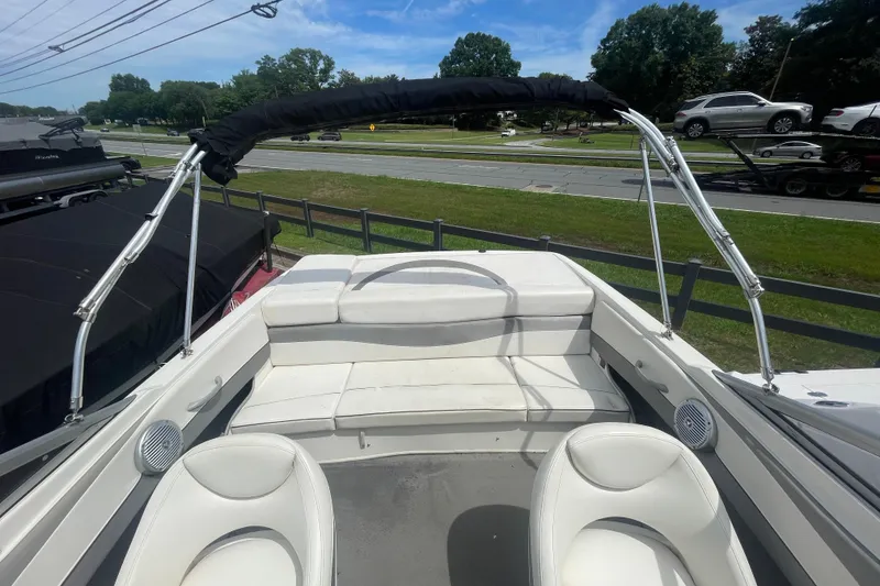 Slide: The Image of 2008 Bayliner 195 Bowrider boat interior with white seating and canopy. - 15