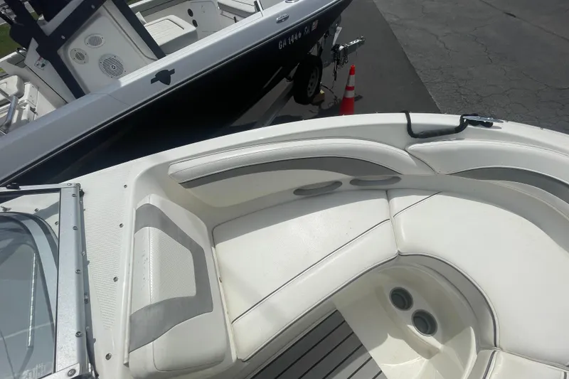 Slide: The Image of 2008 Bayliner 195 Bowrider boat interior with white seating and dashboard view. - 4