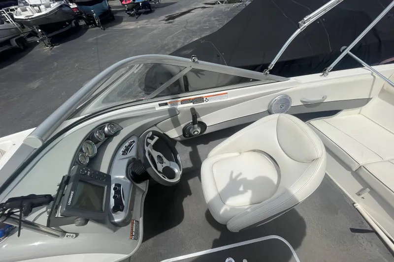 Slide: The Image of 2008 Bayliner 195 Bowrider interior with steering wheel, gauges, and seating. - 6