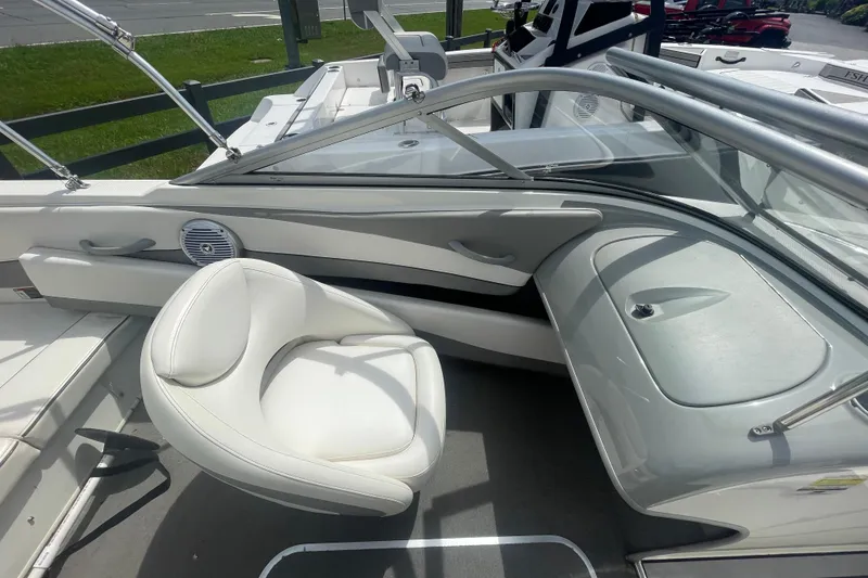 Slide: The Image of 2008 Bayliner 195 Bowrider interior with white seating and sleek dashboard design. - 7