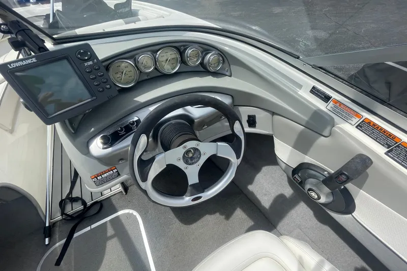 Slide: The Image of 2008 Bayliner 195 Bowrider dashboard with steering wheel, gauges, and Lowrance X96 fishfinder. - 8