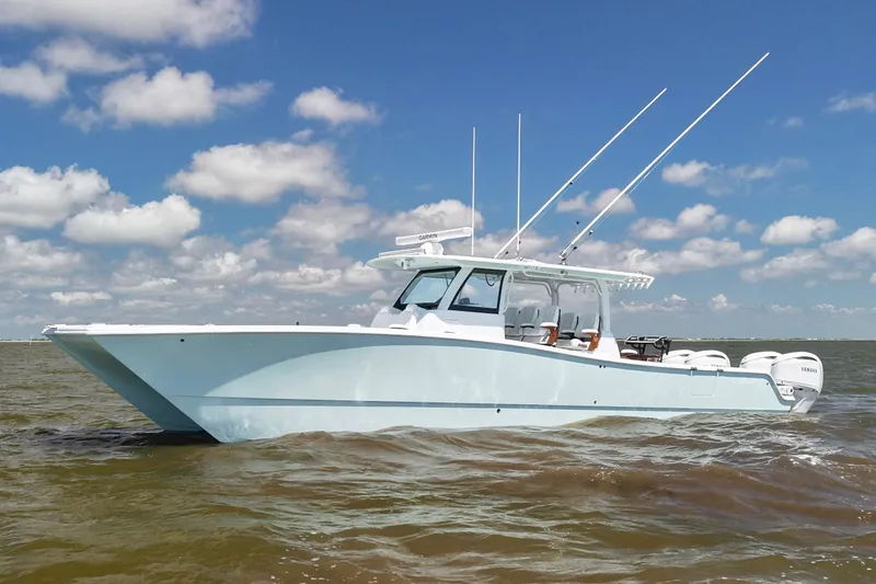 The Image of 2026 Freeman 43 boat on water under blue sky with clouds. - 0
