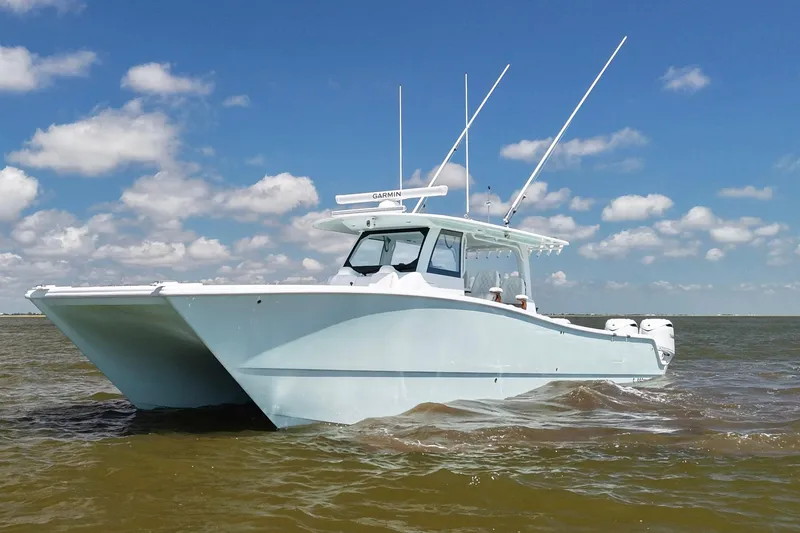 Slide: The Image of 2026 Freeman 43 boat cruising on open water under a clear blue sky. - 1