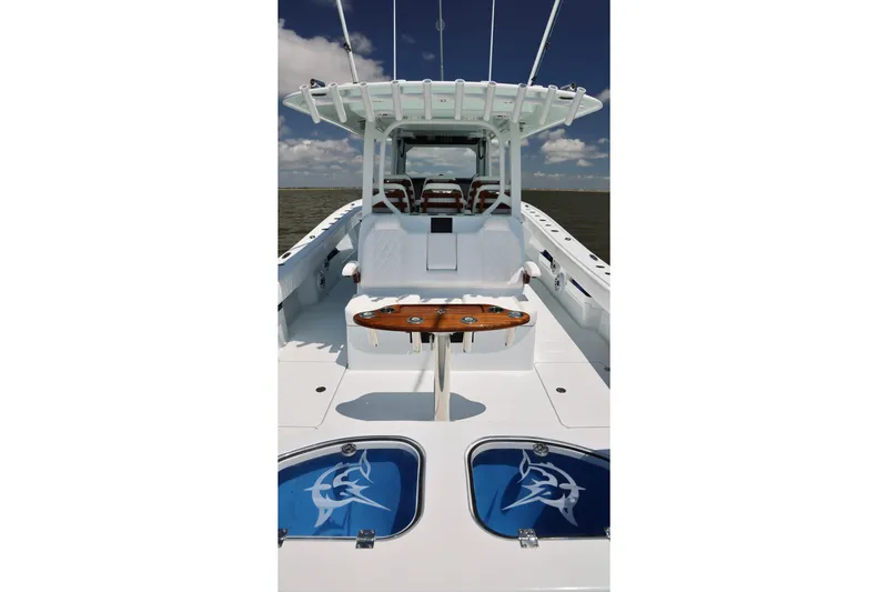 Slide: The Image of 2026 Freeman 43 boat interior with fishing rod holders and seating under a clear sky. - 12