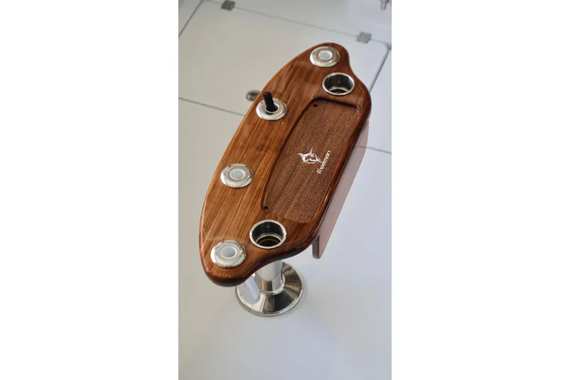 Slide: The Image of Wooden helm station on a 2026 Freeman 43 boat, featuring cup holders and sleek design. - 14