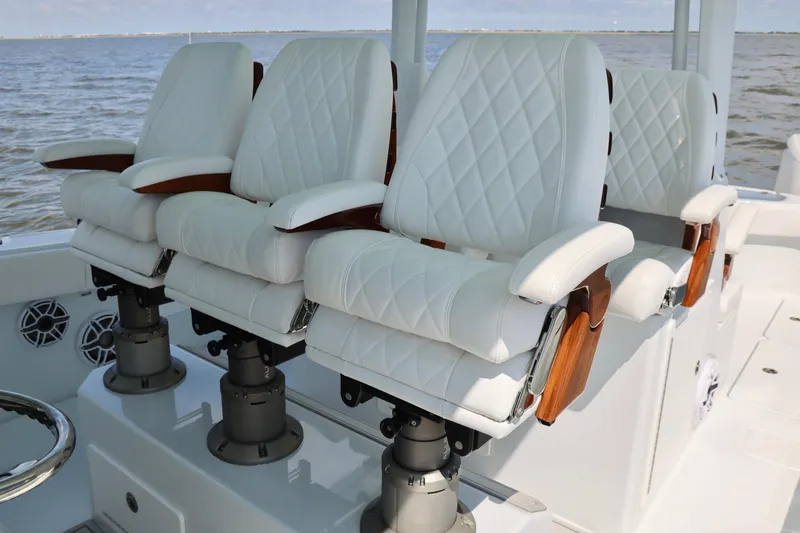 Slide: The Image of Luxurious white seating on a 2026 Freeman 43 boat, featuring elegant diamond stitching. - 15