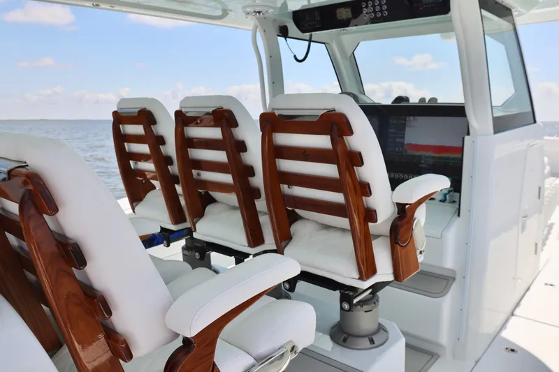 Slide: The Image of Luxury seating on a 2026 Freeman 43 boat, featuring elegant wood and white upholstery. - 16
