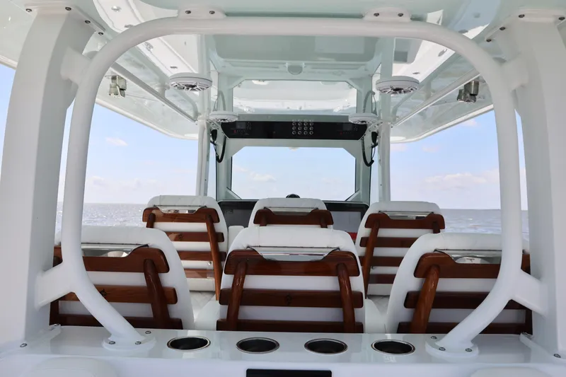 Slide: The Image of Interior view of 2026 Freeman 43 boat with wooden seats and ocean backdrop. - 17