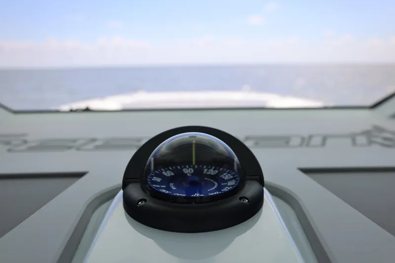 Slide: The Image of Compass on Freeman 43 boat dashboard, 2026 model, with ocean view in background. - 20