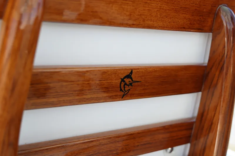 Slide: The Image of Wooden detail on Freeman 43 boat, featuring a marlin logo, 2026 model. - 21