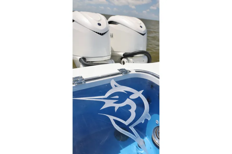 Slide: The Image of Freeman 43 boat with dual engines and marlin logo, 2026 model. - 24