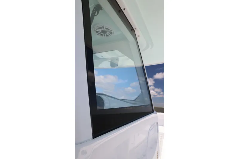 Slide: The Image of Close-up of Freeman 43 boat window reflecting blue sky, 2026 model. - 26