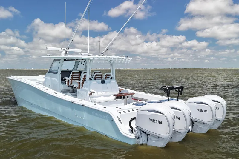 Slide: The Image of 2026 Freeman 43 boat with Yamaha engines on calm water under blue sky. - 3