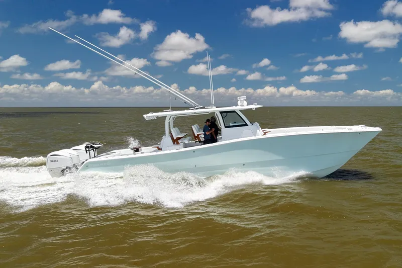 Slide: The Image of 2026 Freeman 43 boat cruising on open water under a clear blue sky. - 6