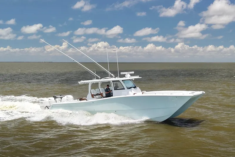 Slide: The Image of 2026 Freeman 43 boat cruising on open water under a partly cloudy sky. - 7