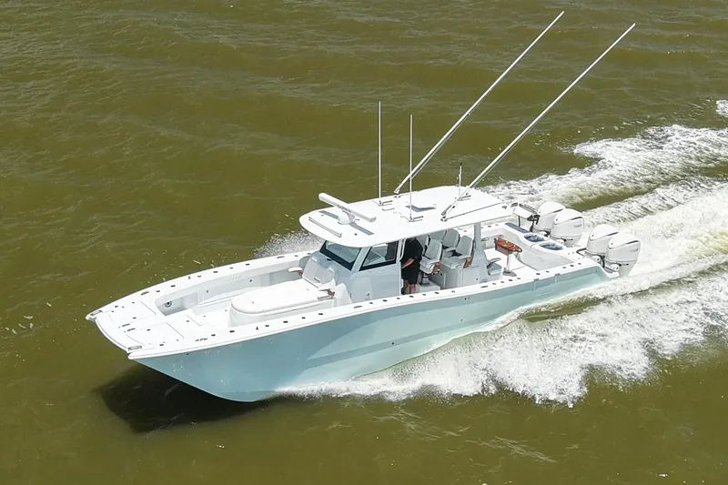 Slide: The Image of 2026 Freeman 43 boat cruising on water with multiple outboard engines. - 9