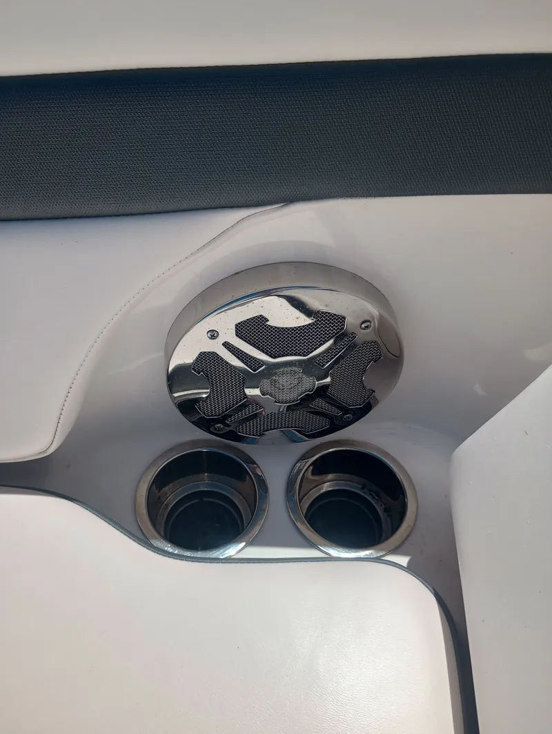 Slide: The Image of Close-up of a speaker and two cup holders on a boat. - 24