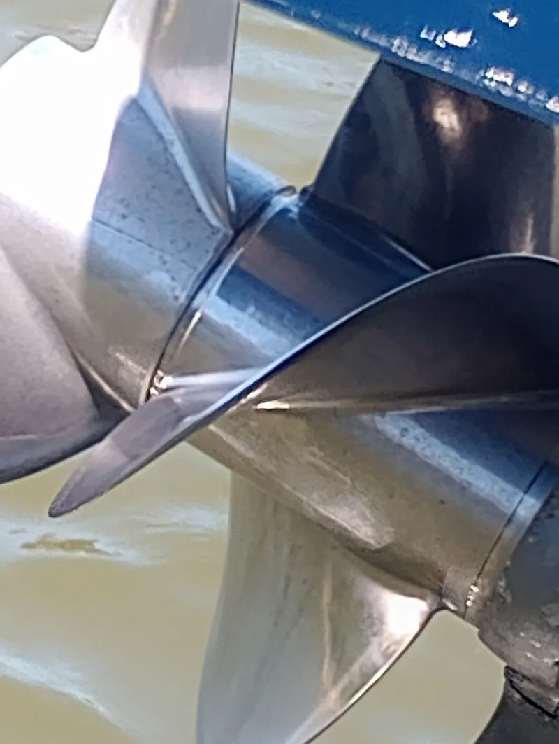 Slide: The Image of Close-up of a shiny boat propeller in the water. - 49