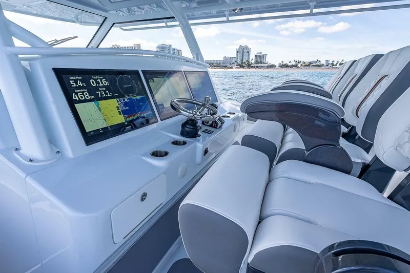 Slide: The Image of 2024 Yellowfin 54 Offshore boat cockpit with advanced navigation displays and luxurious seating. - 24