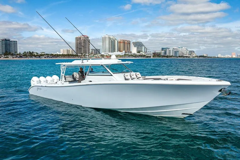 Slide: The Image of 2024 Yellowfin 54 Offshore boat cruising near city skyline on a sunny day. - 3