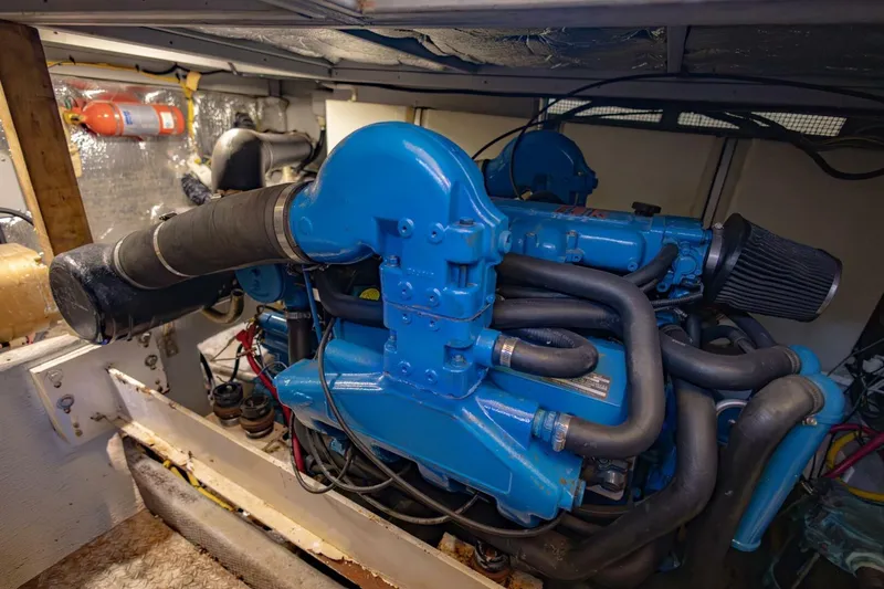 Slide: The Image of Engine room of a 2001 Silverton 410 Sport Bridge with blue marine engine. - 57